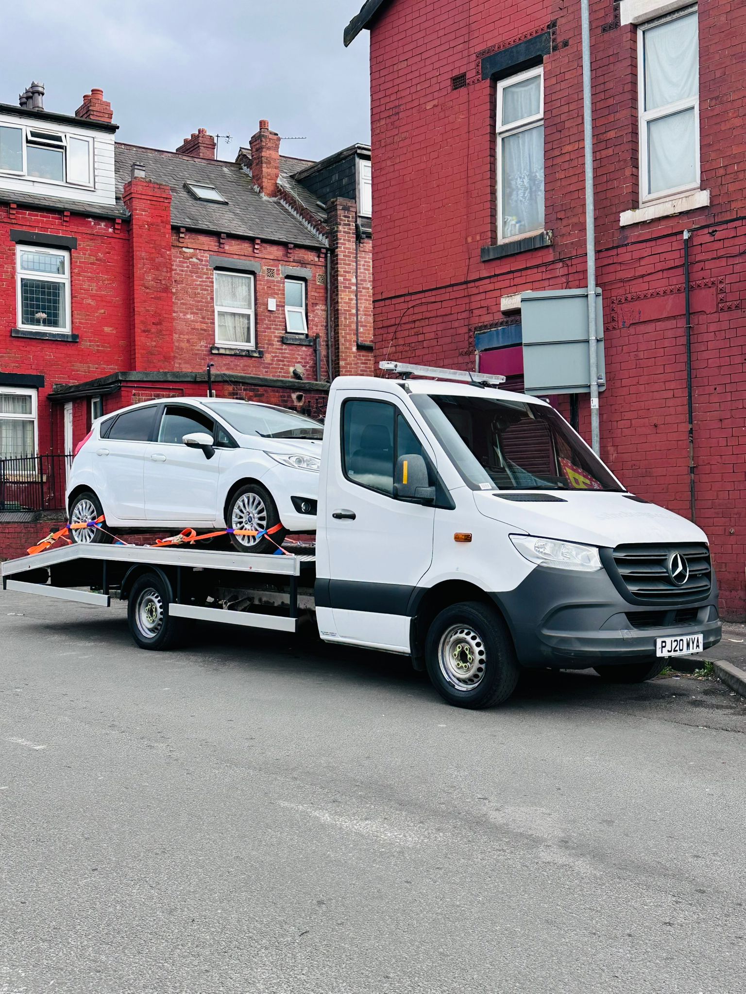 Car on flatbed in residential area